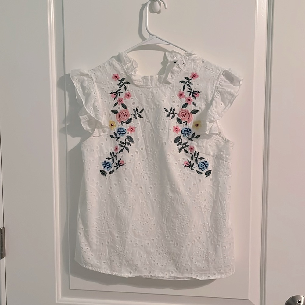White tank top with floral detailing on front